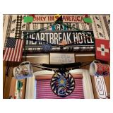 SIGNS, BUNGEES, MUGS HANGING ON WALL