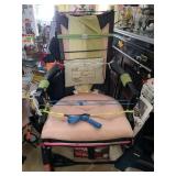 UPHOLSTERED CHAIR WITH ITEMS ATTACHED TO IT,