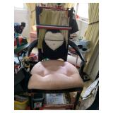 UPHOLSTERED CHAIR WITH ITEMS ATTACHED TO IT,