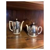 TWO TEAPOTS WITH INSULATED COVERS ONE CHIP ON