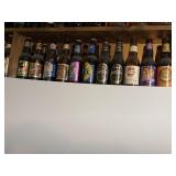 43 MOSTLY FULL BEER BOTTLES AND CELEBRATOR