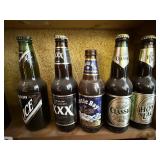 ASSORTED BEER BOTTLES ALL ON RIGHT SIDE OF