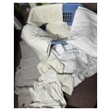 LAUNDRY BASKET FILLED WITH SHEETS, LINENS, TOWELS