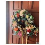 ARTIFICIAL FLORAL WREATH ON DARK WOVEN BASE WITH