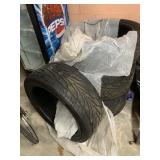 GROUP OF FOUR BLACK AUTOMOBILE TIRES WITH TREADED