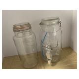 TWO CLEAR GLASS STORAGE JARS, ONE EMBOSSED