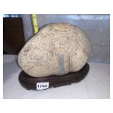 CARVED STONE SCULPTURE ON WOOD STAND