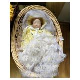 PORCELAIN FACED SLEEPING BABY DOLL IN BASKET