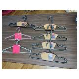 7 SETS OF NEW METAL HANGERS