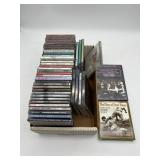 COLLECTION OF COMPACT DISCS AND DVDS IN STORAGE