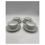 SET OF FOUR PORCELAIN TEACUPS AND SAUCERS WITH