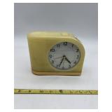 MID-CENTURY MODERN YELLOW PLASTIC ALARM CLOCK.