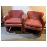 TWO ROSE-COLORED UPHOLSTERED CHAIRS ON WHEELS
