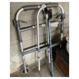 FOLDING WALKER - ALUMINUM FRAME, BLACK HANDLES.