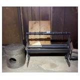 CAST IRON NEWSPAPER LOG ROLLER & METAL ASH BUCKET.
