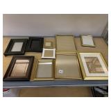 ASSORTED GOLD AND DARK PICTURE FRAMES.