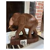 CARVED WOODEN ELEPHANT FIGURINE, TUSKS, ON BASE.