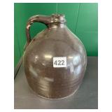 DARK BROWN GLOSSY STONEWARE JUG W/ HANDLE.