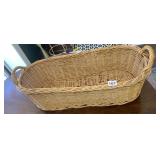 WICKER OVAL BASKET W/ INTEGRATED HANDLES.