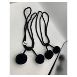 BLACK ROPE TIE-BACKS W/ POM-POMS.