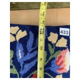 NAVY BLUE FLORAL HOOKED TEXTILE PILLOW.