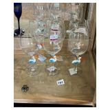 CLEAR GLASS STEMWARE, DECORATIVE SWAN FIGURES.