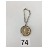 1900 MORGAN SILVER DOLLAR, MOUNTED IN METAL