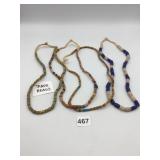 ASSORTED TRADE BEADS, STRUNG ON FIBER CORD,