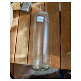 CLEAR TEXTURED GLASS BOTTLE, CYLINDRICAL FORM.