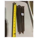 METAL SPIKES, RUSTED FINISH, POINTED ENDS.