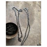 ASSORTED CHAINSAW CHAINS, METAL CANISTER STORAGE.