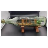 12" GREEN GLASS BOTTLE WITH MODEL SHIP INSIDE