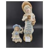 (2) CERAMIC FIGURINES - 1 SEATED & 1 STANDING