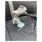 Chipped porcelain figurine of a flying seagull,