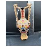 terracotta vase made in the sgraffito style. It