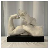 Plaster or resin sculpture depicting a flexing man
