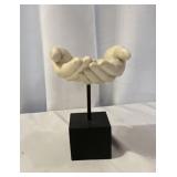 Plaster or resin sculpture depicting open hands