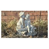 Garden statue of little boy kissing little girl.