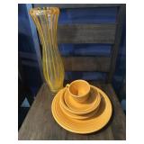 5 piece orange Fiesta dinner setting and a vase