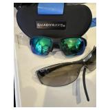 A pair of Shady Ray and one scratched RayBans