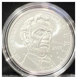2009 ABE LINCOLN COMM. UNC SILVER DOLLAR -