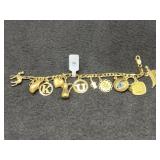 18K GOLD CHARM BRACELET AND 12 GOLD CHARMS (SOME