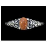 Sterling silver prong set goldstone ring in