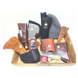 Lot: assorted holsters, pistol cases, stock pad,