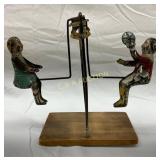 Tin Swing Toy with Painted Figures on Wood Base