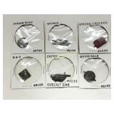 Six Metal Tobacco Tags in Paper Sleeves