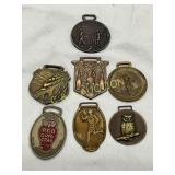 Seven Metal Watch Fobs Featuring Various Designs