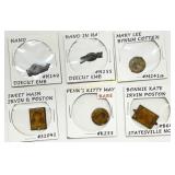 Six Token and Stamp Items in Protective Sleeves