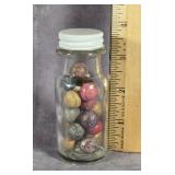SMALL GLASS JAR OF ANTIQUE CLAY MARBLES