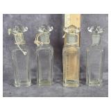 FOUR SMALL CLEAR GLASS CRUETS OR PERFUME BOTTLES